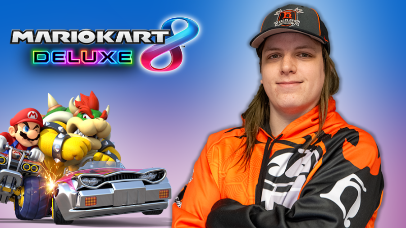 Corbin is a white person with sandy-brown long hair. They are wearing a hat with the Heidelberg Esports logo and the Heidelberg Esports hoodie with the student prince logo on the chest and the h on the sleeve. They are superimposed on a gradient blue and purple background, with the mario kart 8 deluxe logo and mario and bowser in cars competing superimposed to their left.