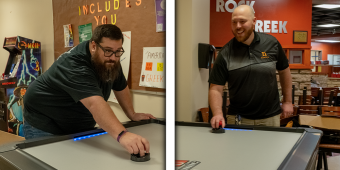 Director of Residence Life, Dennis Loconti (L) playing air hockey against Jake McGraw (R), Director of Campus Safety and Compliance in the new Berg Arcade